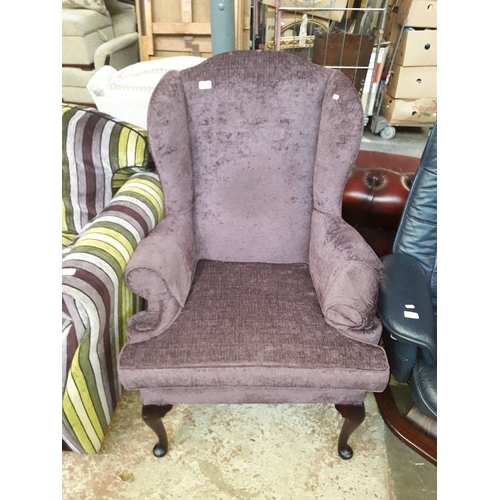 968 - A purple wing back armchair