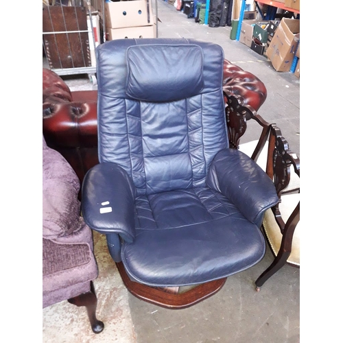 969 - A blue leather swivel armchair