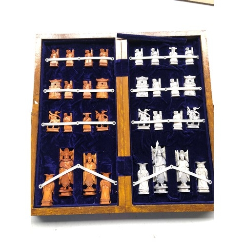 982 - A Chinese ivory chess set, early 20th century, with board.