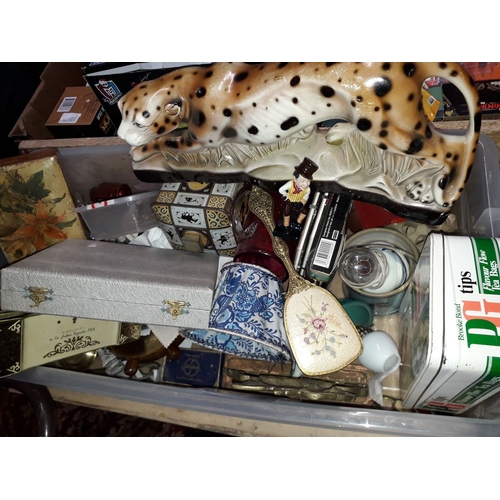 1062 - A box of misc. including a pottery leopard, treen metalware, Doulton Dickens, tins etc.