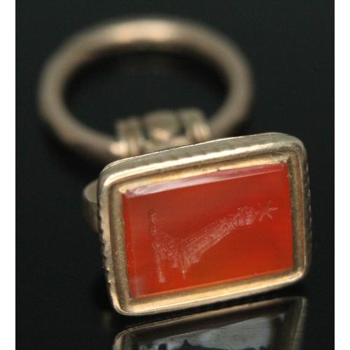 100 - A 19th century seal fob set with a carnelian intaglio seal, length 28mm, gross wt. 5.25g.