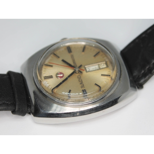 109 - A vintage stainless steel Rado Conway automatic wristwatch with signed champagne dial, red center sw... 