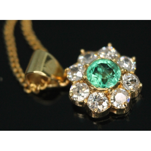 110 - A diamond and emerald cluster pendant, the central bezel set old European cut emerald weighing appro... 