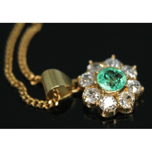 110 - A diamond and emerald cluster pendant, the central bezel set old European cut emerald weighing appro... 