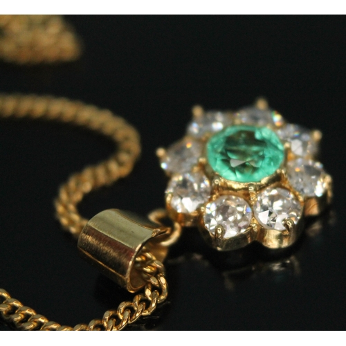 110 - A diamond and emerald cluster pendant, the central bezel set old European cut emerald weighing appro... 