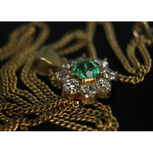 110 - A diamond and emerald cluster pendant, the central bezel set old European cut emerald weighing appro... 