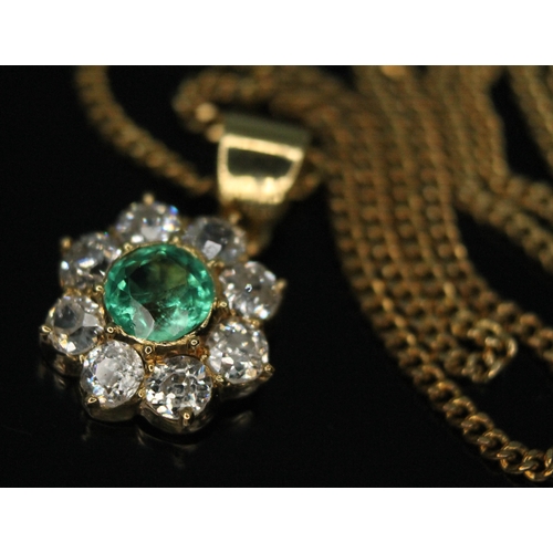 110 - A diamond and emerald cluster pendant, the central bezel set old European cut emerald weighing appro... 