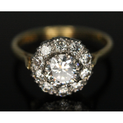 111 - A diamond cluster ring, ten claw set central modern round brilliant cut diamond weighing approx. 0.7... 