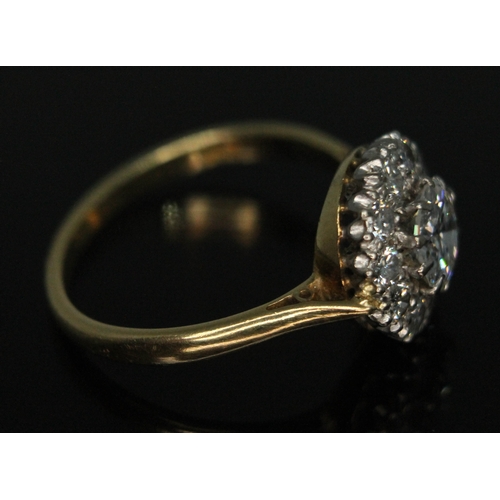 111 - A diamond cluster ring, ten claw set central modern round brilliant cut diamond weighing approx. 0.7... 