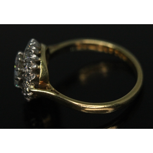 111 - A diamond cluster ring, ten claw set central modern round brilliant cut diamond weighing approx. 0.7... 