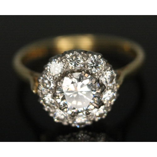 111 - A diamond cluster ring, ten claw set central modern round brilliant cut diamond weighing approx. 0.7... 