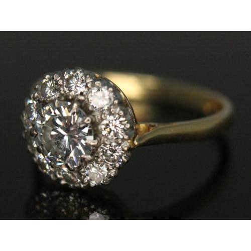 111 - A diamond cluster ring, ten claw set central modern round brilliant cut diamond weighing approx. 0.7... 