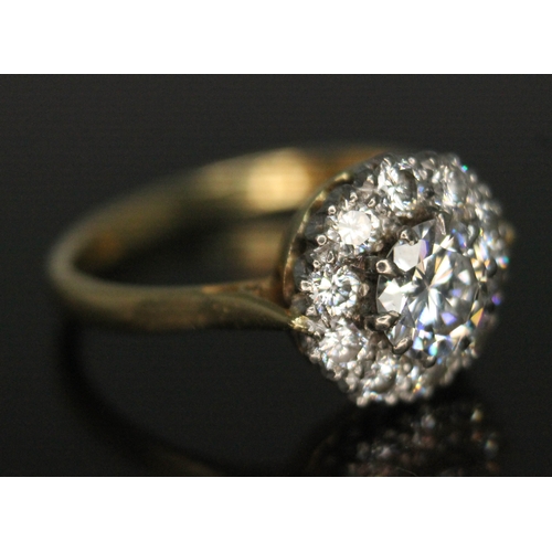 111 - A diamond cluster ring, ten claw set central modern round brilliant cut diamond weighing approx. 0.7... 