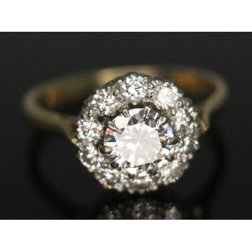 111 - A diamond cluster ring, ten claw set central modern round brilliant cut diamond weighing approx. 0.7... 