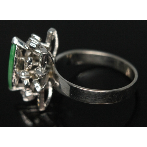 112 - A jade and diamond cocktail ring, the central marquis shaped jadeite jade cabochon measuring approx.... 