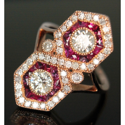 139 - A diamond and ruby cluster ring featuring two modern round brilliant cut diamonds weighing approx. 0... 