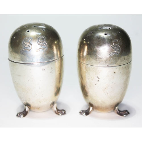 255 - A pair of Victorian silver salt and pepper pots in the manner of Christopher Dresser, sponsor's mark... 