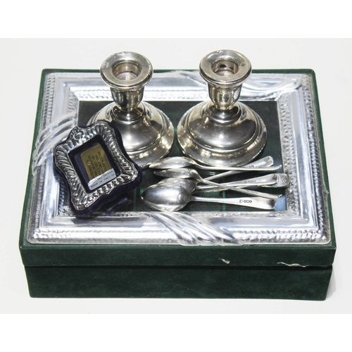 264 - Assorted hallmarked silver comprising a pair of candlesticks, a photograph frame, a set of five spoo... 
