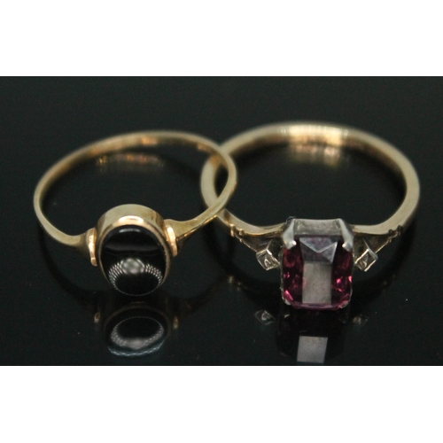 297 - A hallmarked 9ct gold signet ring set with black onyx and a ring set with purple past marked '9ct', ... 