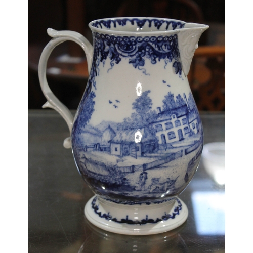 322 - An 18th century blue and white jug with mask spout, scroll handle, the body decorated in blue and wh...