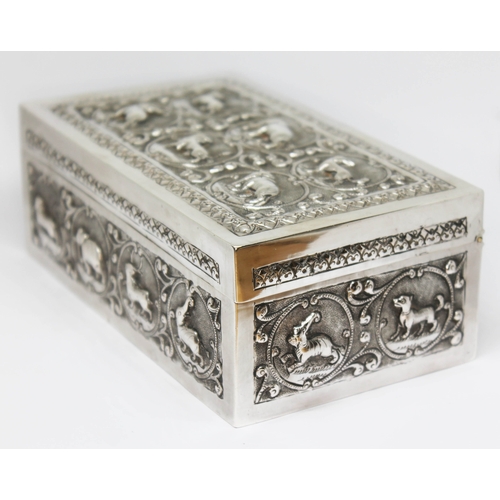 99 - An Indian cigarette box, embossed all over with animals, cedar lined, marked 'K90', length 15.5cm.