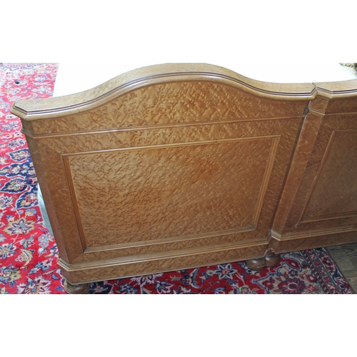 85 - A continental birds eye maple double bed circa 1900, the heads with carved scrolls, with super king ... 