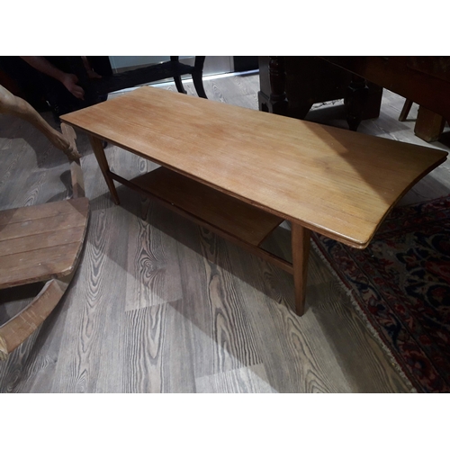 83 - A danish style teak surfboard coffee table, length 121cm.