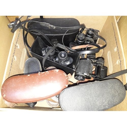 492 - A box of 11 various binoculars, most with cases.