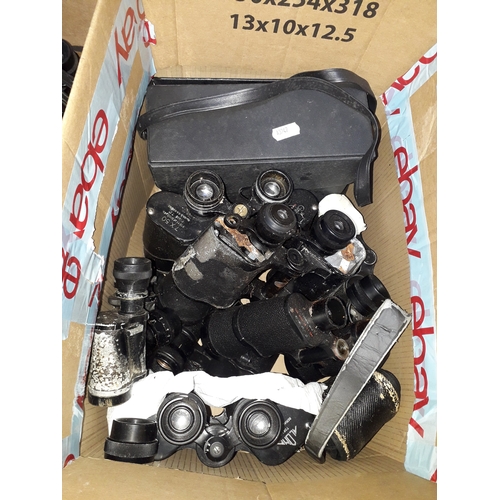 493 - A box of assorted binoculars for spares and repairs.