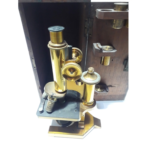 494 - An R. & J.Beck Ltd of London microscope with wooden case and 4 brass containers, serial number 23981... 