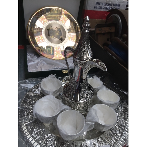 226 - White metal Arabic tea set and an etched metal wall plate depicting Roman archeological sites in Lib... 