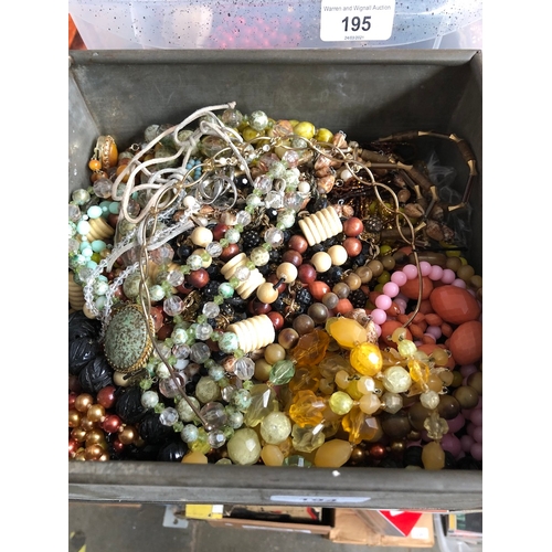 466 - A tin box of costume jewellery