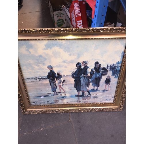 461 - An oil on canvas in gilt frame, depicting women waiting for the catch on the beach.