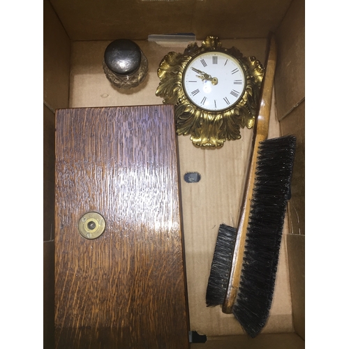 815 - A box of collectables to include small brass wall clock, boxed weighing scales, brush and a hallmark... 