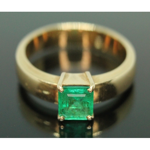 134 - A emerald ring, the rectangular emerald cut emerald weighing approx. 0.73 carats, the band marked '1... 