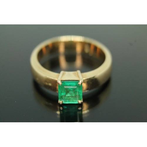 134 - A emerald ring, the rectangular emerald cut emerald weighing approx. 0.73 carats, the band marked '1... 