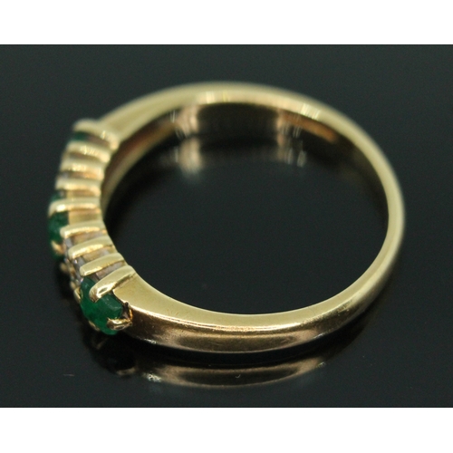 137 - A hallmarked 18ct gold emerald and diamond cluster ring, the cluster measuring approx. 16mm x 4mm, g... 