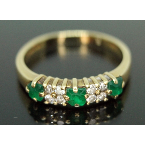 137 - A hallmarked 18ct gold emerald and diamond cluster ring, the cluster measuring approx. 16mm x 4mm, g... 