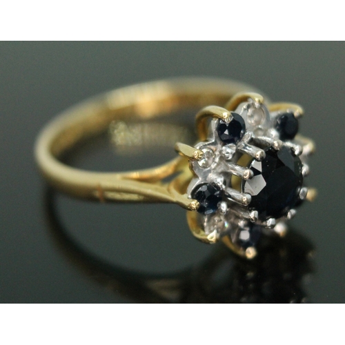 140 - A sapphire and diamond cluster ring, the clustering diameter approx. 11mm, hallmarked 18ct gold band... 