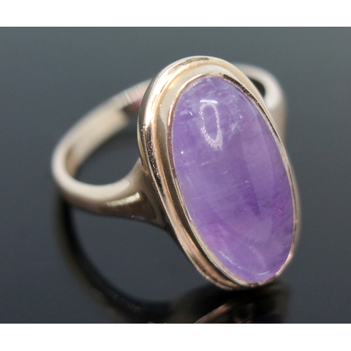 162 - A hallmarked 9ct gold amethyst cabochon ring, the bezel set oval cabochon measuring approx. 19mm x 9... 