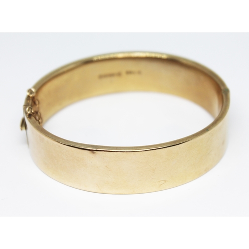 170 - A hallmarked 9ct gold bangle engraved with diamond design, sponsor's mark 'M, G&S', Chester 1935, di... 