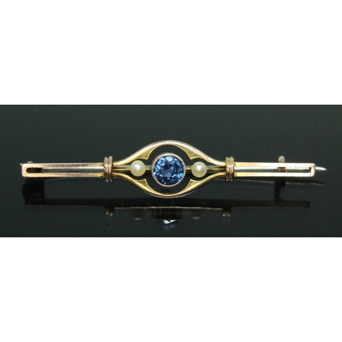 176 - An early 20th century sapphire and seed pearl bar brooch, the central millegrain bezel set round cut... 