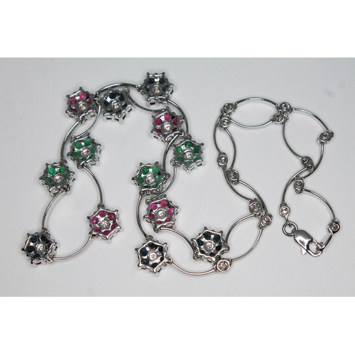 180 - A diamond, sapphire, ruby and emerald necklace, featuring thirteen alternate seven stone clusters wi... 