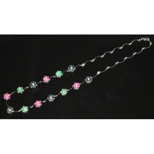 180 - A diamond, sapphire, ruby and emerald necklace, featuring thirteen alternate seven stone clusters wi... 