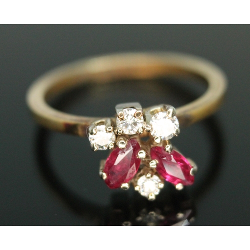 183 - A diamond and ruby cluster ring, the random cluster set with two marquis rubies and three modern rou... 