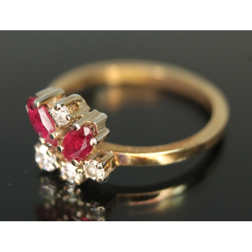 183 - A diamond and ruby cluster ring, the random cluster set with two marquis rubies and three modern rou... 