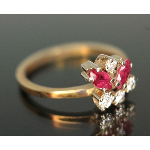 183 - A diamond and ruby cluster ring, the random cluster set with two marquis rubies and three modern rou... 