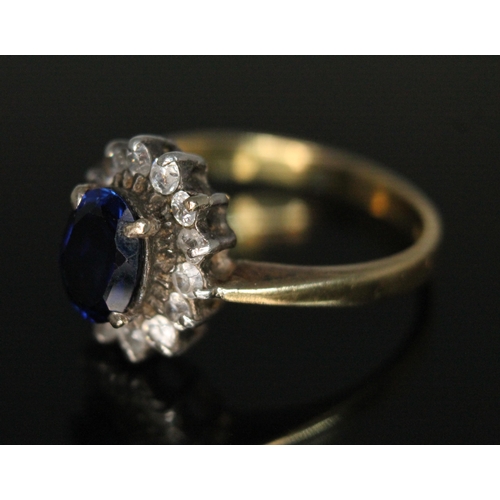 189 - A hallmarked 18ct gold synthetic blue sapphire and colourless stone cluster ring, the cluster measur... 