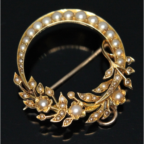 203 - A late Victorian/Edwardian split pearl pendant brooch of cresent and floral form, the largest pearl ... 