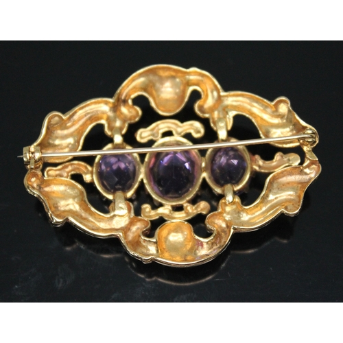 207 - A 9ct gold brooch of scroll form and set with three oval amethysts, 52mm x 36mm, hallmarked 9ct gold... 